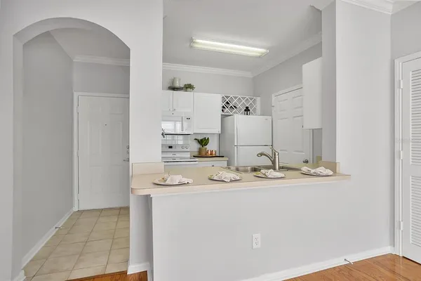 a view of a kitchen with white cabinets