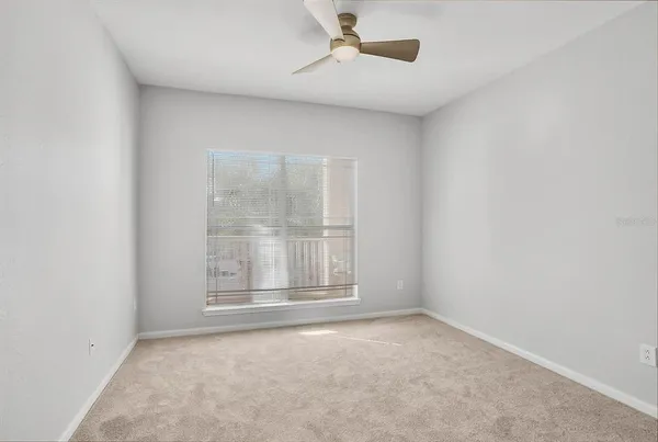 an empty room with closet and a bathroom