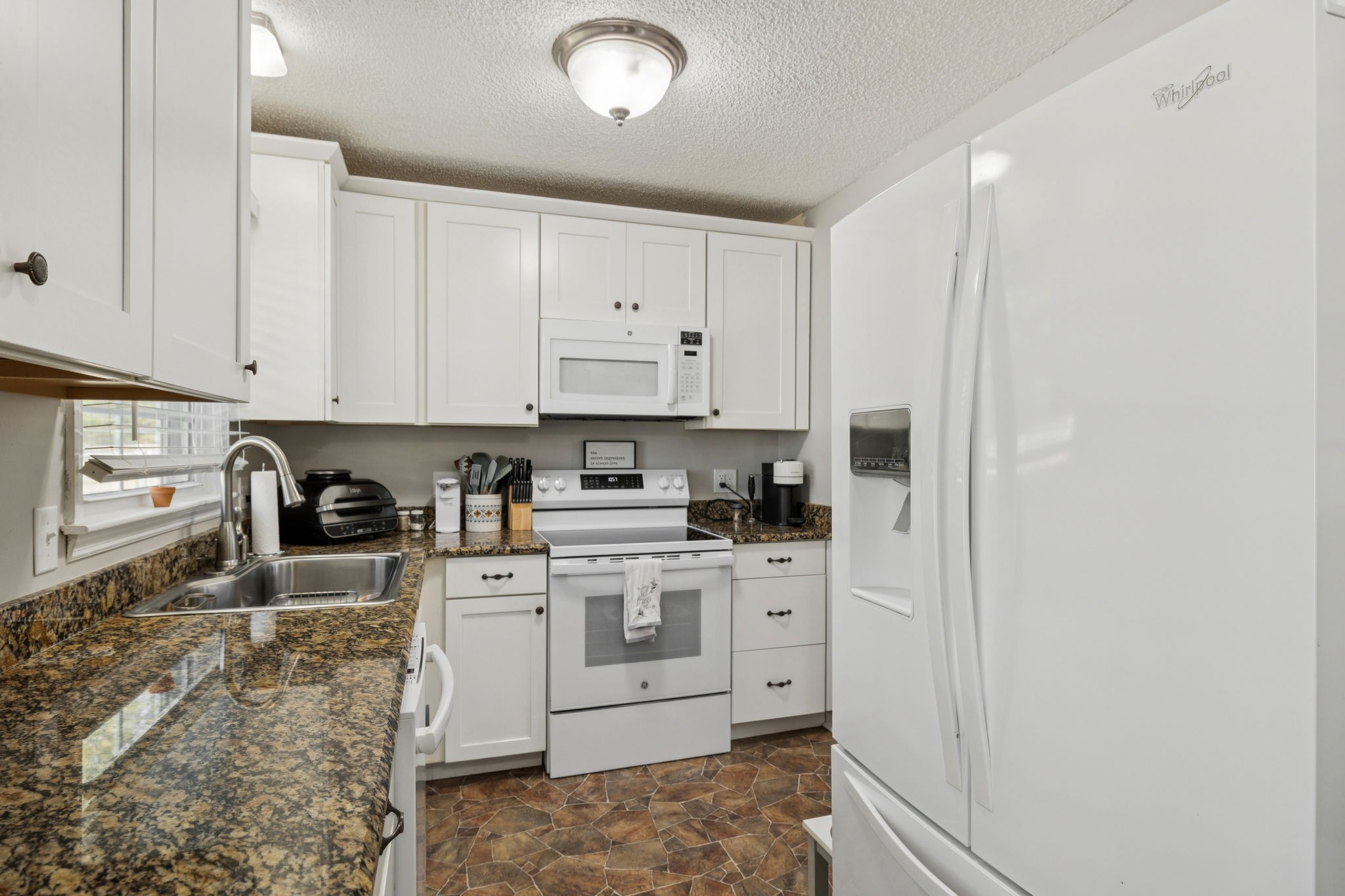 900 Ridge West Hermitage, TN 37076 - Photo 12 of 38 a kitchen with stainless steel appliances granite countertop a stove a sink and white cabinets