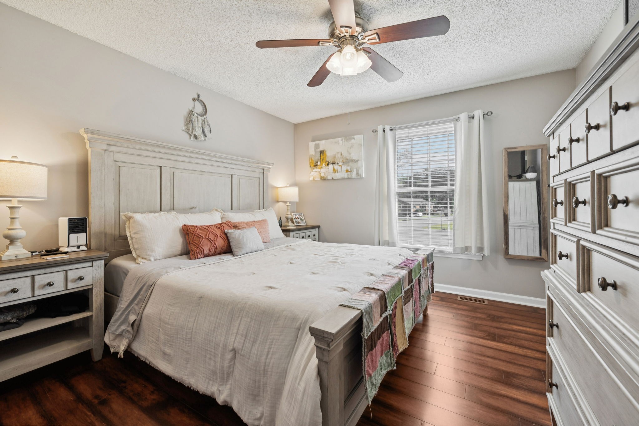900 Ridge West Hermitage, TN 37076 - Photo 18 of 38 a spacious bedroom with a bed a dresser and wooden floor