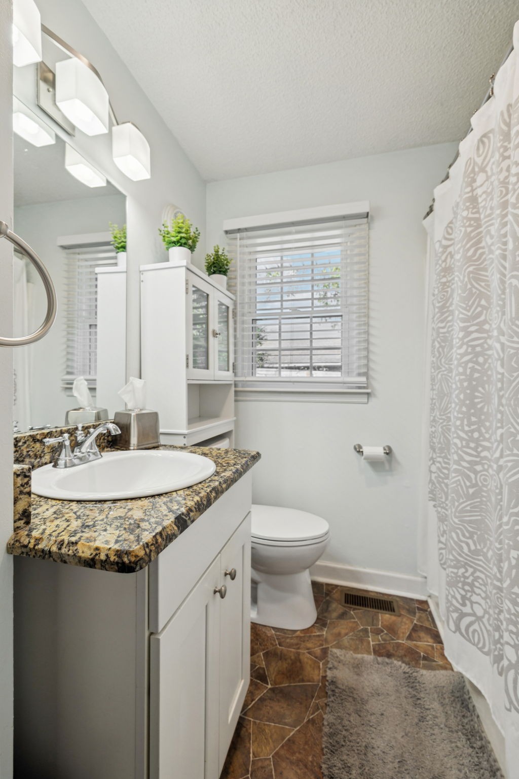 900 Ridge West Hermitage, TN 37076 - Photo 21 of 38 a bathroom with a granite countertop sink a toilet and a mirror