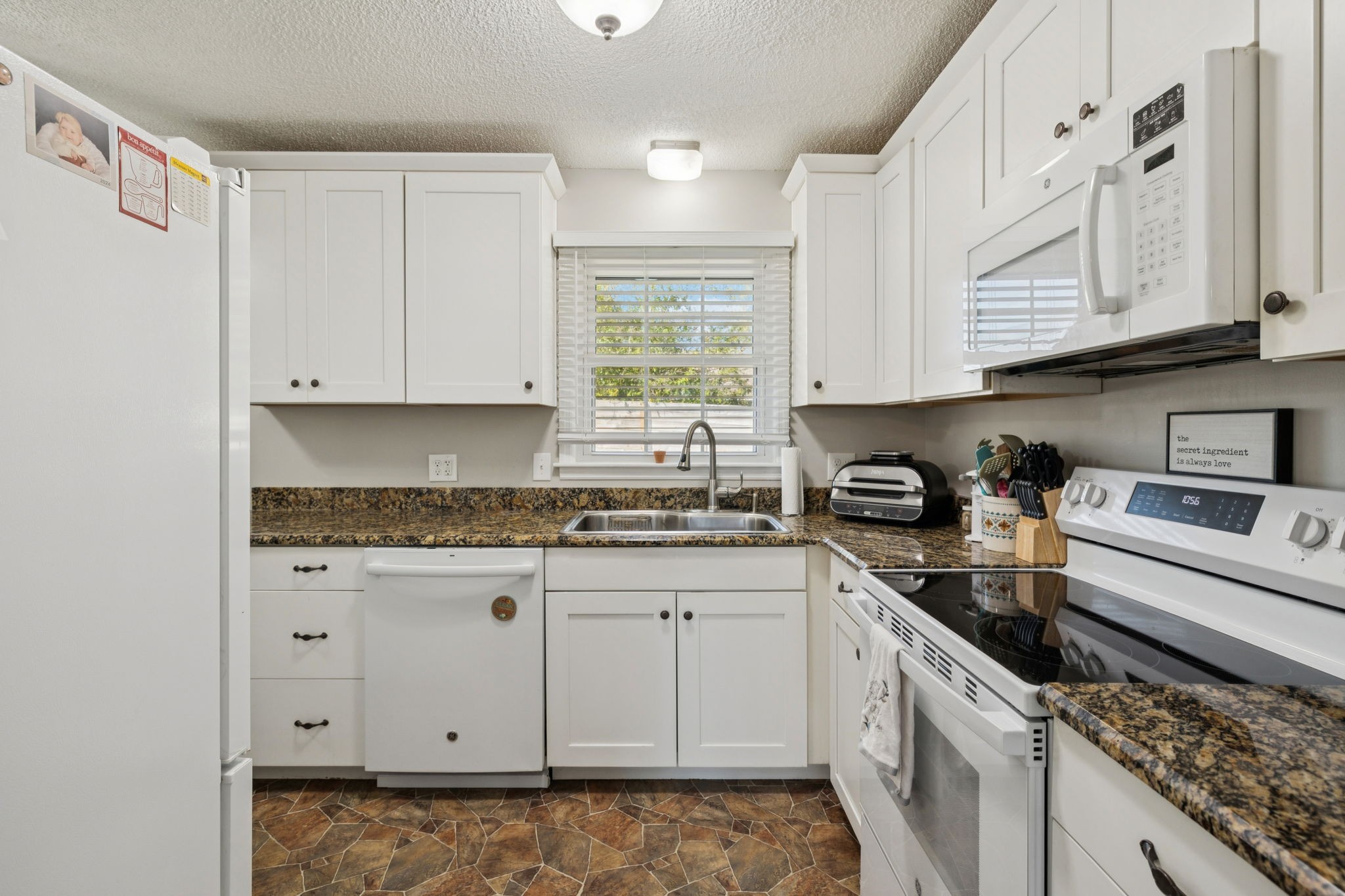 900 Ridge West Hermitage, TN 37076 - Photo 10 of 38 a kitchen with granite countertop white cabinets and white appliances