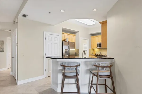 a dining room with a sink and a mirror