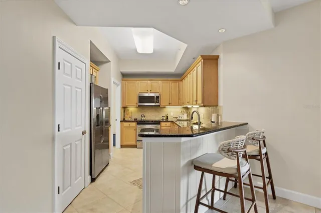 a kitchen with stainless steel appliances granite countertop a stove and a refrigerator