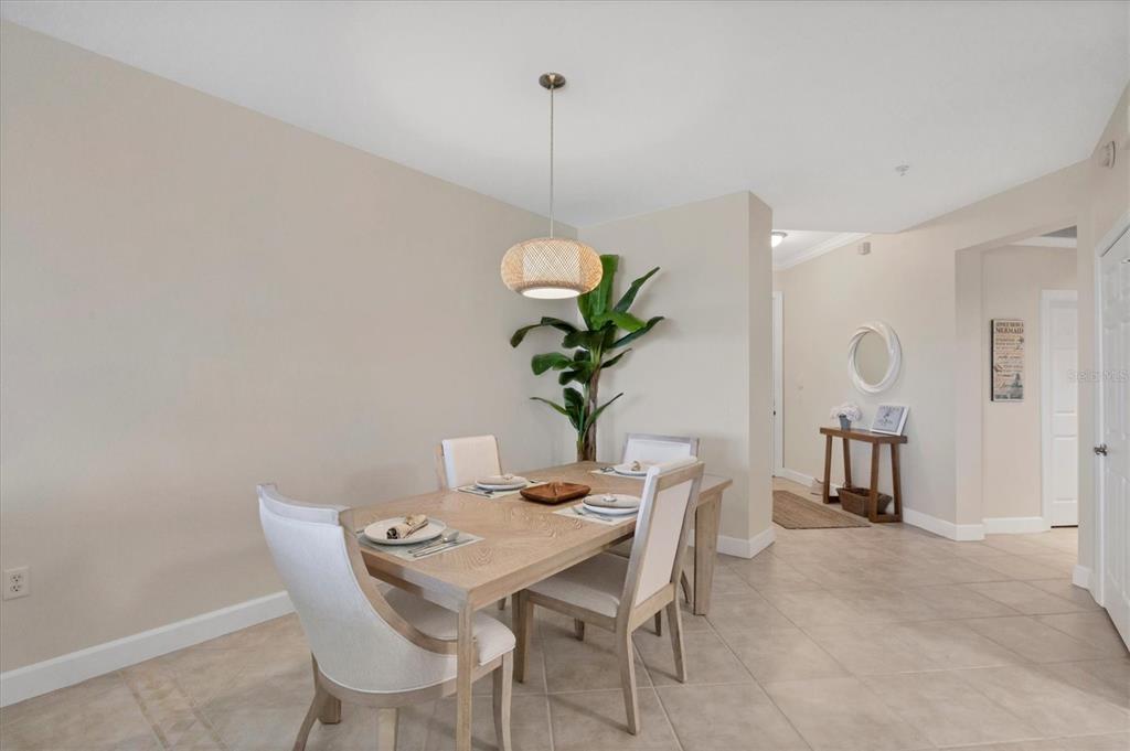 8541 Amberjack Circle, Unit 203 Englewood, FL 34224 - Photo 16 of 52 a dining room with furniture and wooden floor