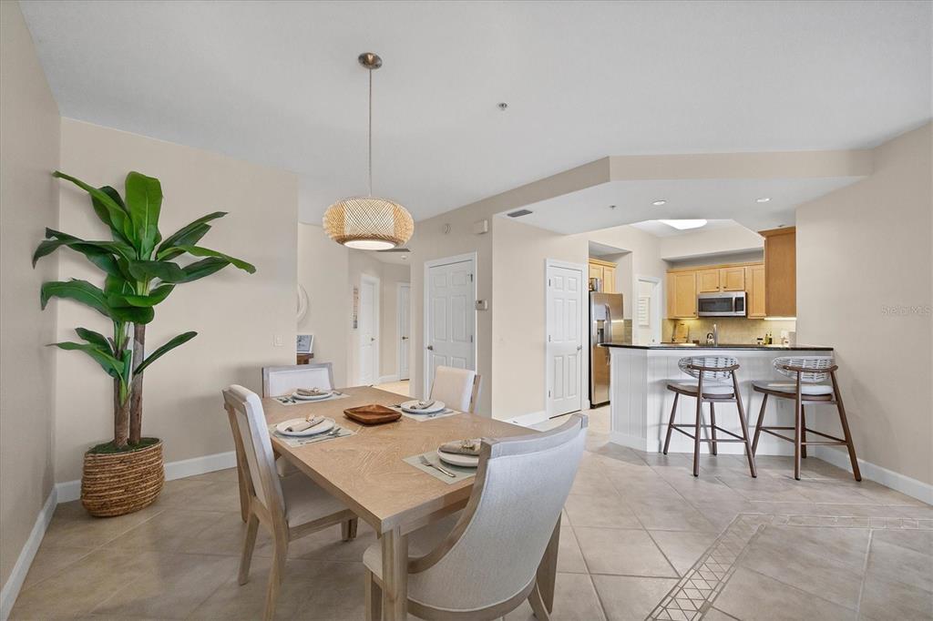 8541 Amberjack Circle, Unit 203 Englewood, FL 34224 - Photo 17 of 52 a view of a dining room with furniture and wooden floor