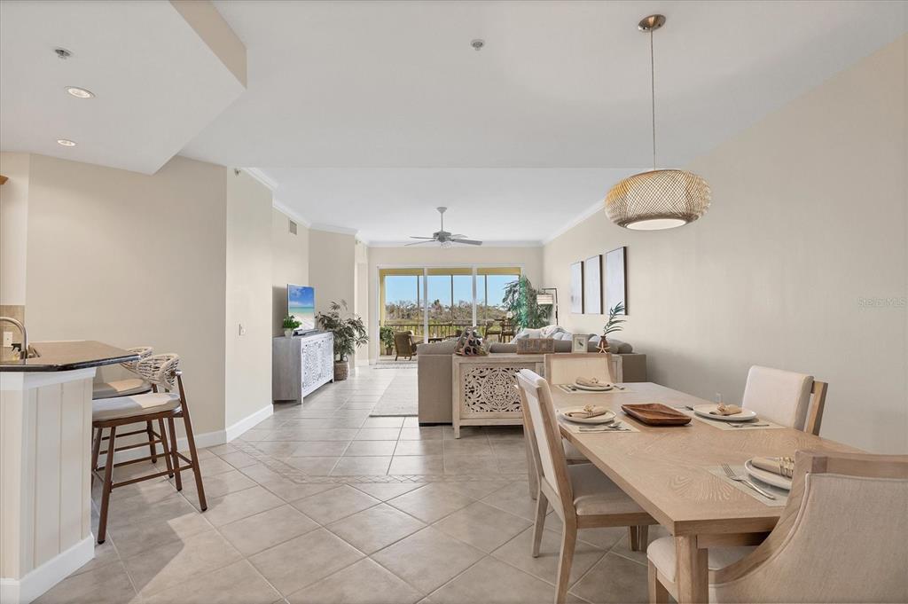 8541 Amberjack Circle, Unit 203 Englewood, FL 34224 - Photo 19 of 52 a view of a dining room and livingroom with furniture wooden floor a rug and a chandelier