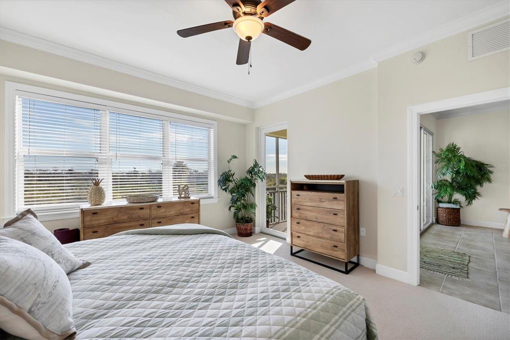 8541 Amberjack Circle, Unit 203 Englewood, FL 34224 - Photo 21 of 52 a bedroom with a bed a dresser and a large window