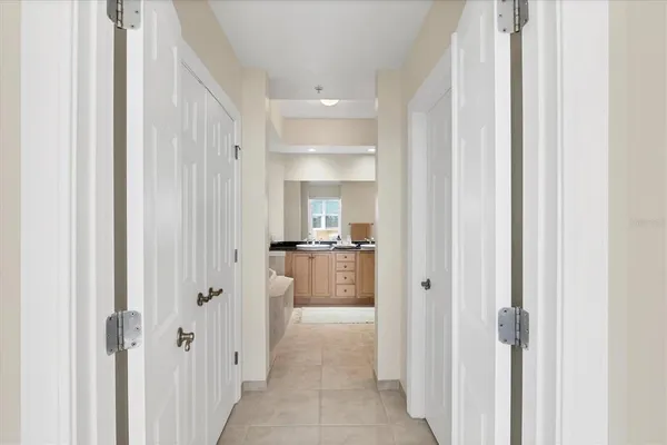 a view of a hallway with a livingroom and a bathroom with sink