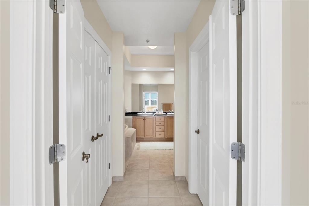 8541 Amberjack Circle, Unit 203 Englewood, FL 34224 - Photo 23 of 52 a view of a hallway with a livingroom and a bathroom with sink