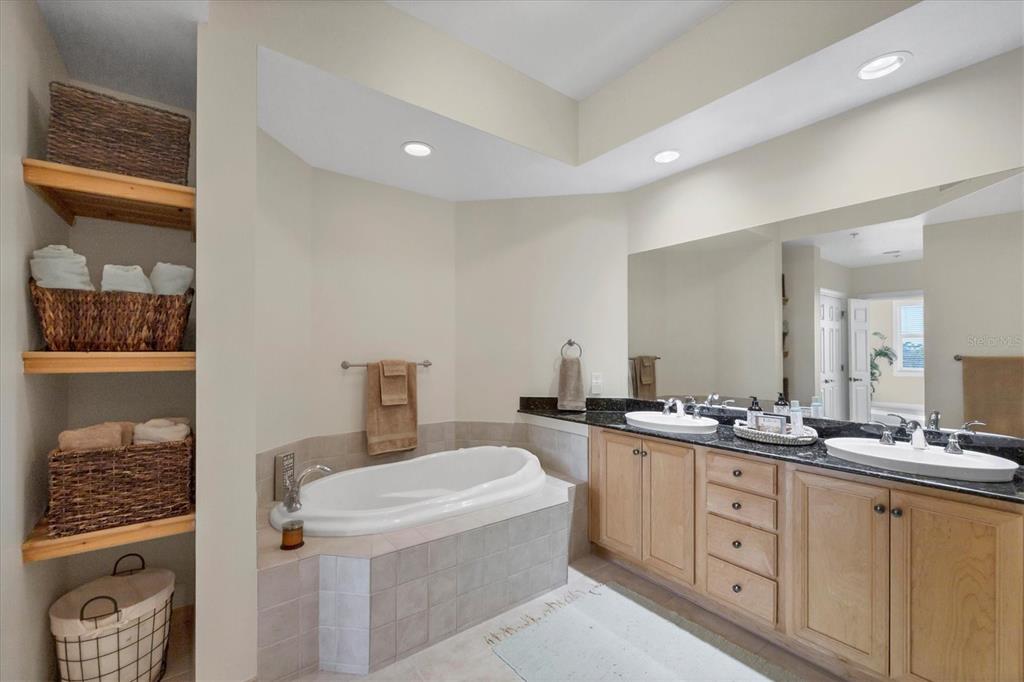 8541 Amberjack Circle, Unit 203 Englewood, FL 34224 - Photo 25 of 52 a bathroom with a double vanity sink a mirror a and toilet