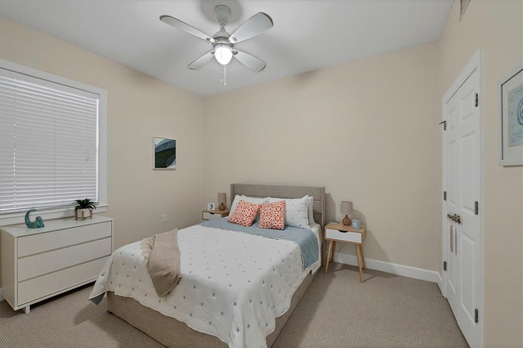 8541 Amberjack Circle, Unit 203 Englewood, FL 34224 - Photo 27 of 52 a bedroom with a bed and a chandelier