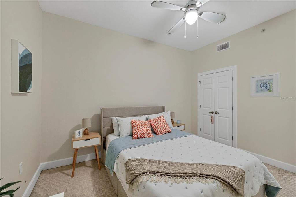 8541 Amberjack Circle, Unit 203 Englewood, FL 34224 - Photo 28 of 52 a bedroom with a bed and a chandelier
