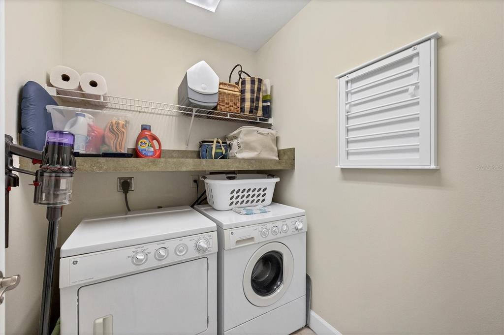 8541 Amberjack Circle, Unit 203 Englewood, FL 34224 - Photo 30 of 52 a utility room with dryer washer and a view of living