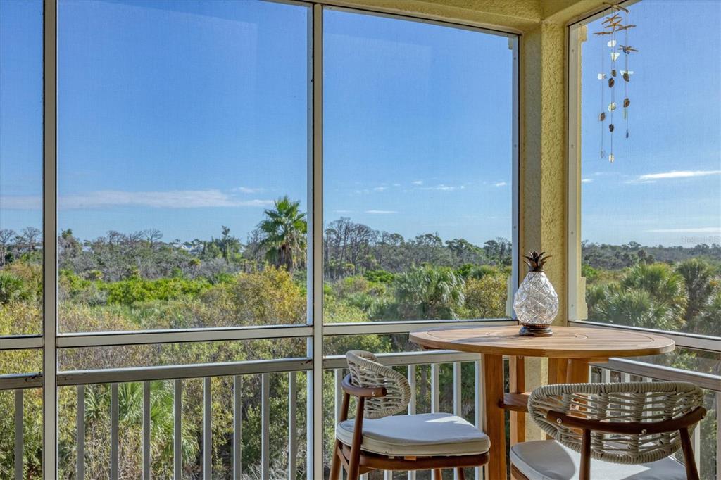 8541 Amberjack Circle, Unit 203 Englewood, FL 34224 - Photo 32 of 52 a view of a city from a balcony with furniture