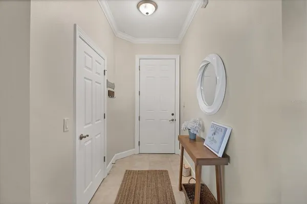 a view of a hallway with wooden floor and entryway