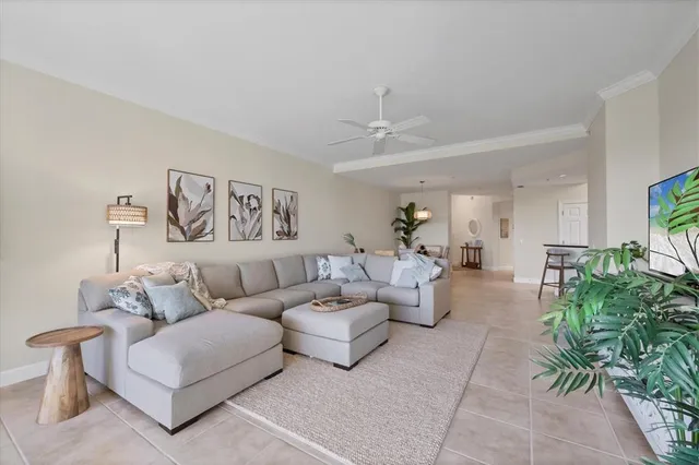 a living room with furniture and a potted plant