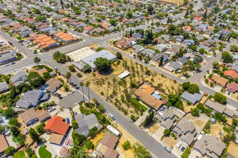 an aerial view of residential building and trees around
