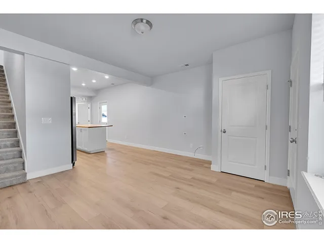 a kitchen with stainless steel appliances granite countertop a stove a refrigerator a sink and a oven