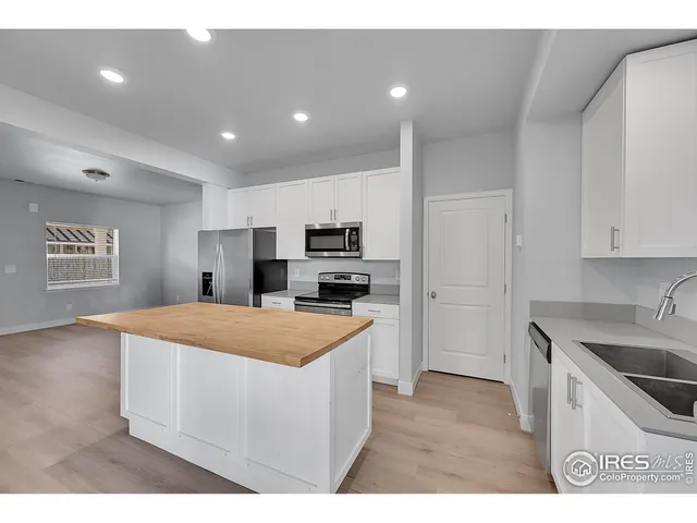 a kitchen with a sink cabinets and appliances