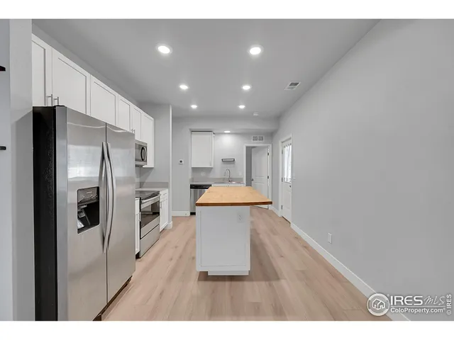 a kitchen with stainless steel appliances a stove a microwave and a refrigerator