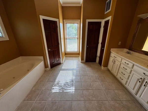 a bathroom with a tub shower and a sink