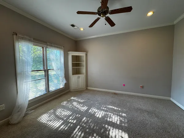 a view of a livingroom with a ceiling fan and window