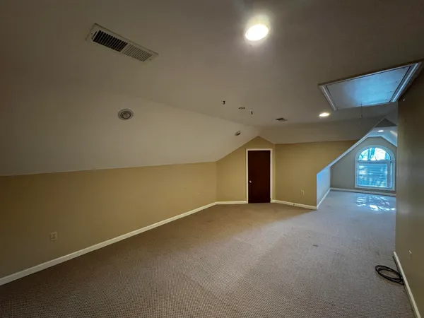 an empty room with projector and windows