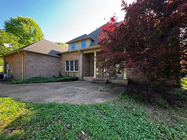 a view of a house with a tree