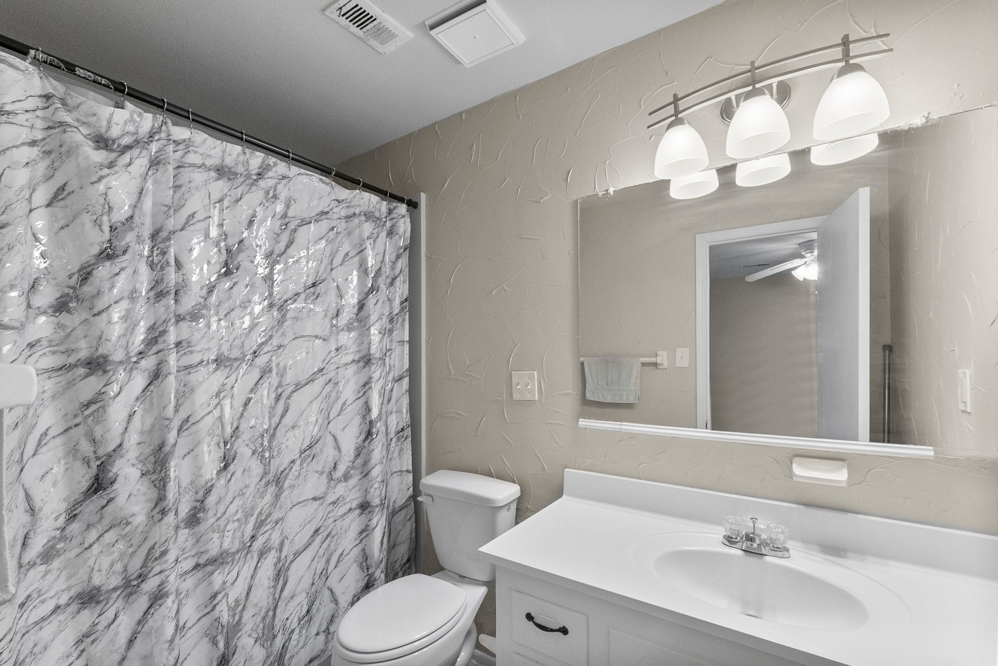 407 West Semands Street Conroe, TX 77301 - Photo 26 of 28 a bathroom with a sink a toilet and shower curtain