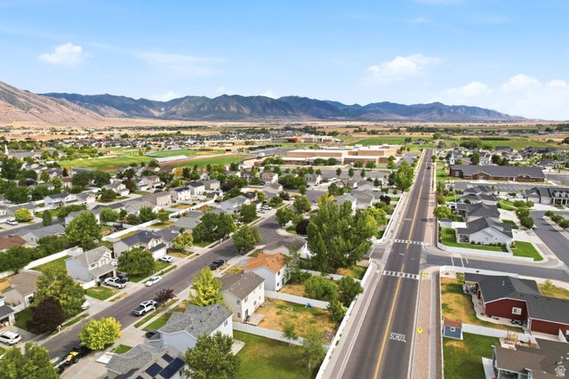5485 Heather Way Tooele, UT 84074 - Photo 39 of 41 Aerial perspective showcasing a residential neighborhood with distant mountains