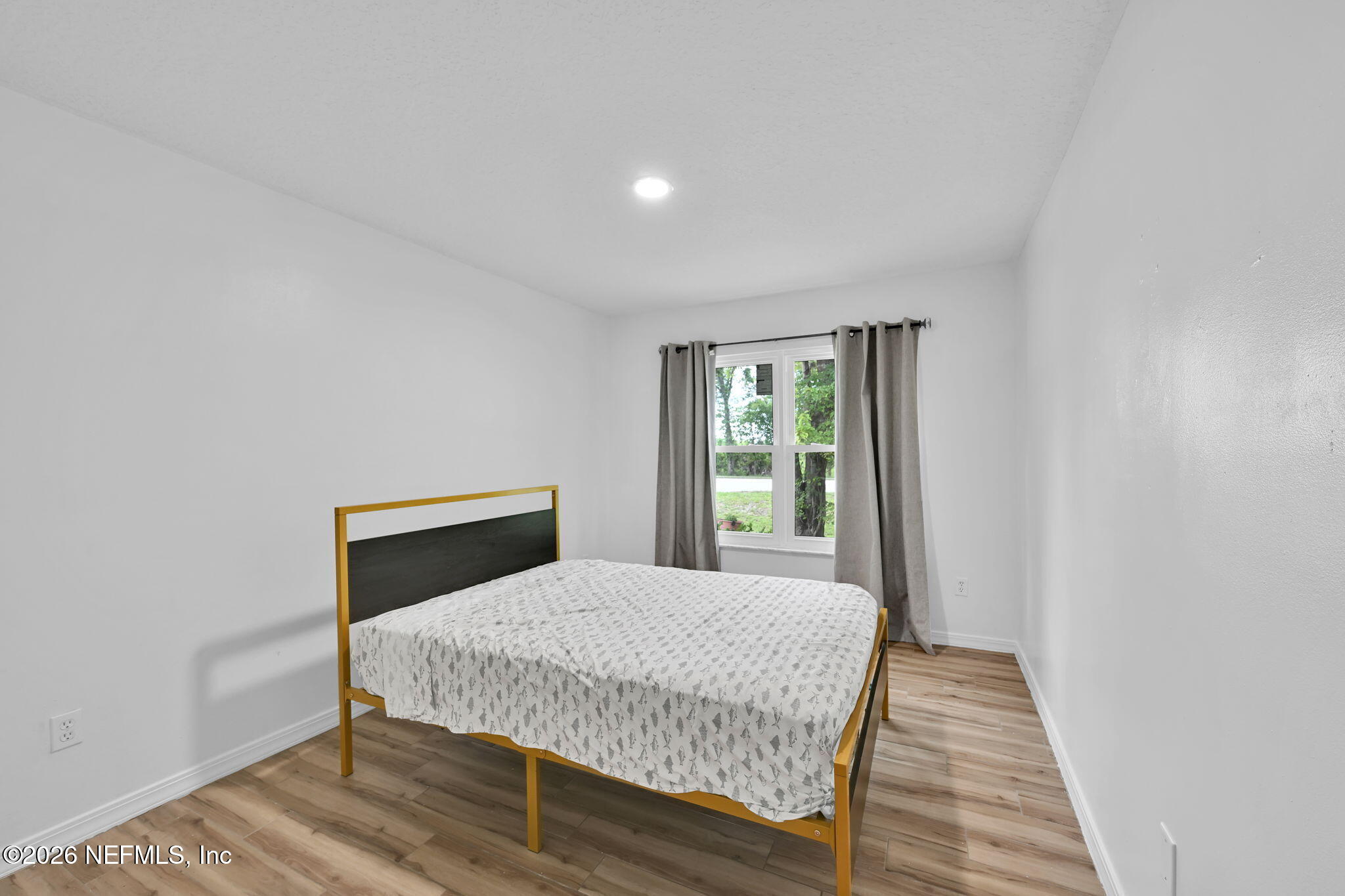 1110 Woodlawn Road, Unit D St. Augustine, FL 32084 - Photo 14 of 40 a bedroom with a bed and wooden floor