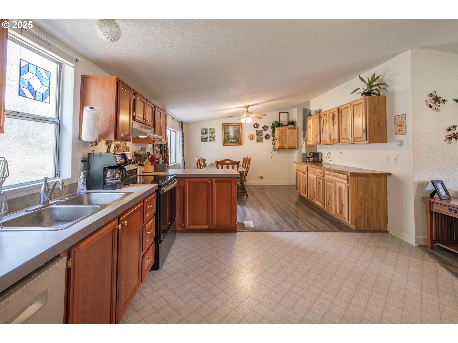 31101 Berlin Road Lebanon, OR 97355 - Photo 11 of 41 a kitchen with stainless steel appliances granite countertop a sink dishwasher stove and wooden cabinets