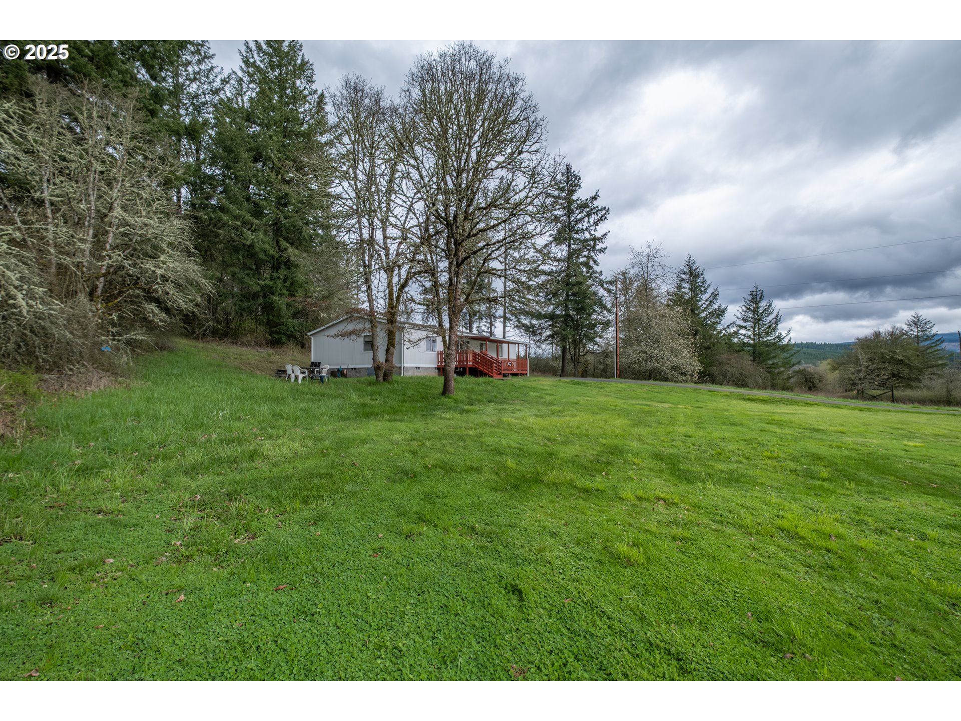31101 Berlin Road Lebanon, OR 97355 - Photo 33 of 41 a view of a grassy field with trees in the background