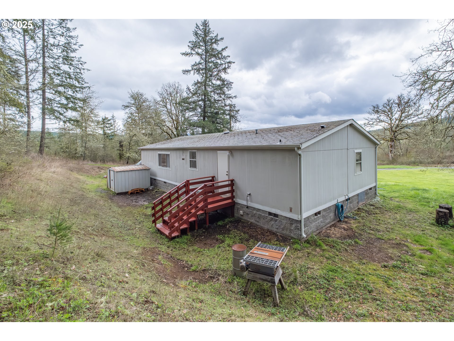 31101 Berlin Road Lebanon, OR 97355 - Photo 34 of 41 a backyard of a house with table and chairs