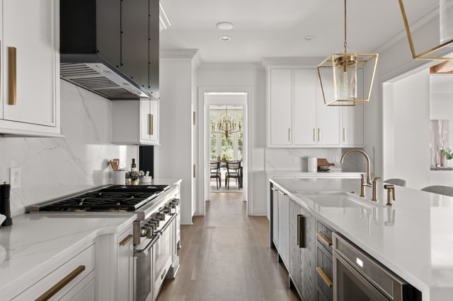 a kitchen with stainless steel appliances a sink stove and cabinets