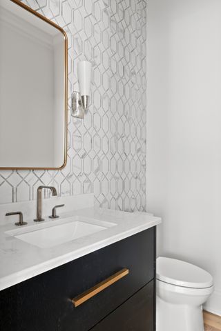 a bathroom with a sink a toilet and mirror