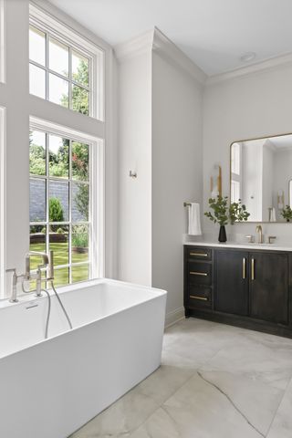 a living room with a large window and a kitchen island