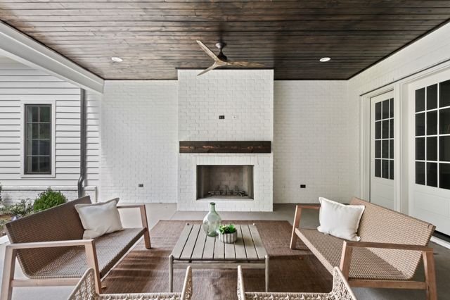 a front view of a house with outdoor seating