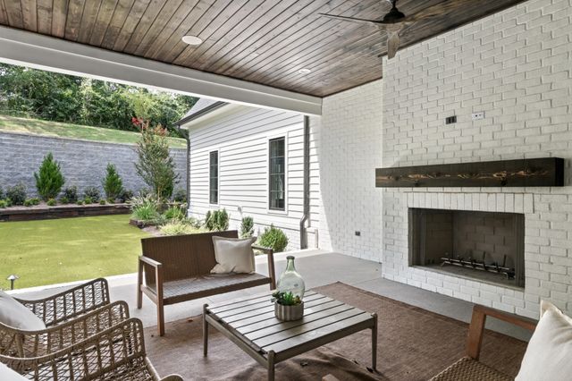 a living room with patio furniture and a fireplace