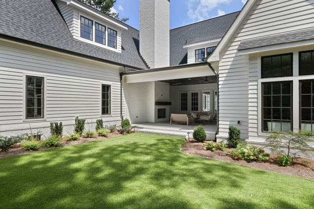 a front view of a house with sitting area and garden
