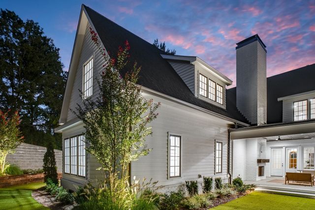 a view of a house with a flower garden