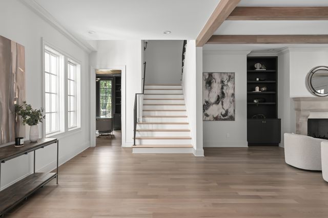 a view of a hallway view with wooden floor and staircase