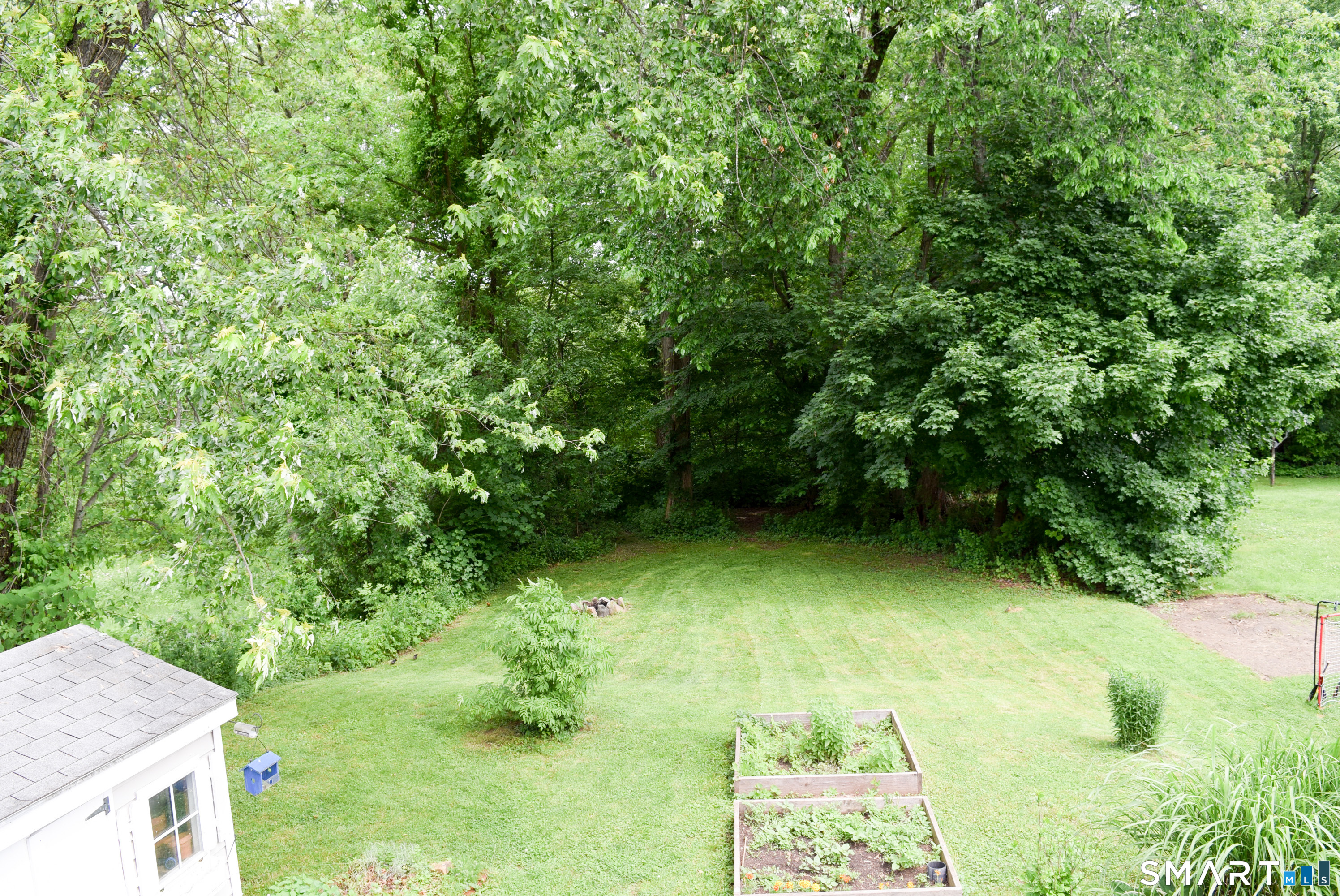 76 Sinclair Street Windsor, CT 06095 - Photo 5 of 32 The property line extends well into the woods but the clearing makes a great level yard