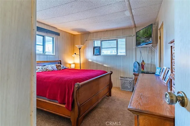 a spacious bathroom with a double vanity sink a mirror and a toilet