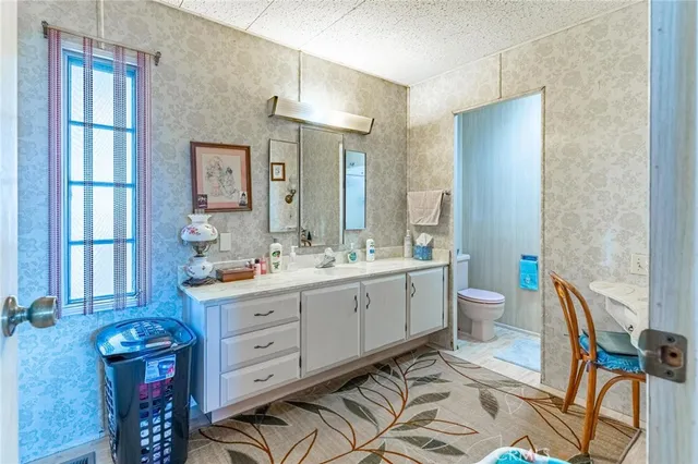 a bedroom with a bed and a workspace