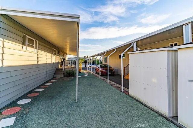 a kitchen with stainless steel appliances a stove a sink and white cabinets