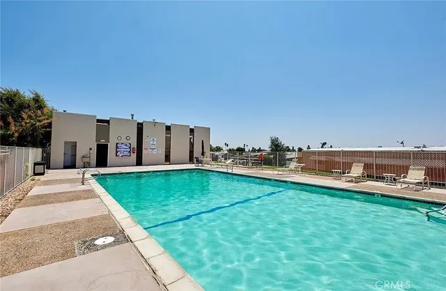 a room with pool table and windows