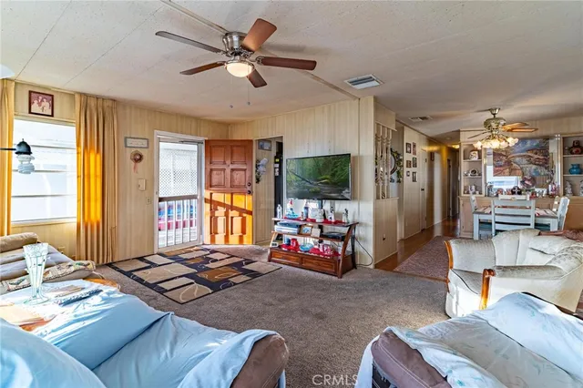 a dining room with furniture a chandelier and a rug