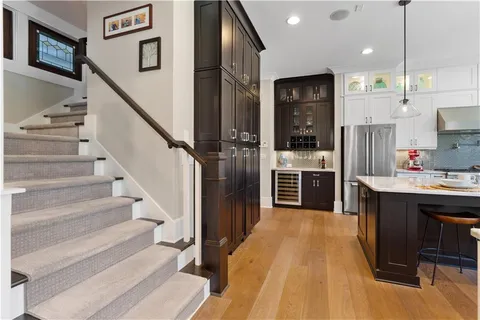 a kitchen with a stove and wooden floor